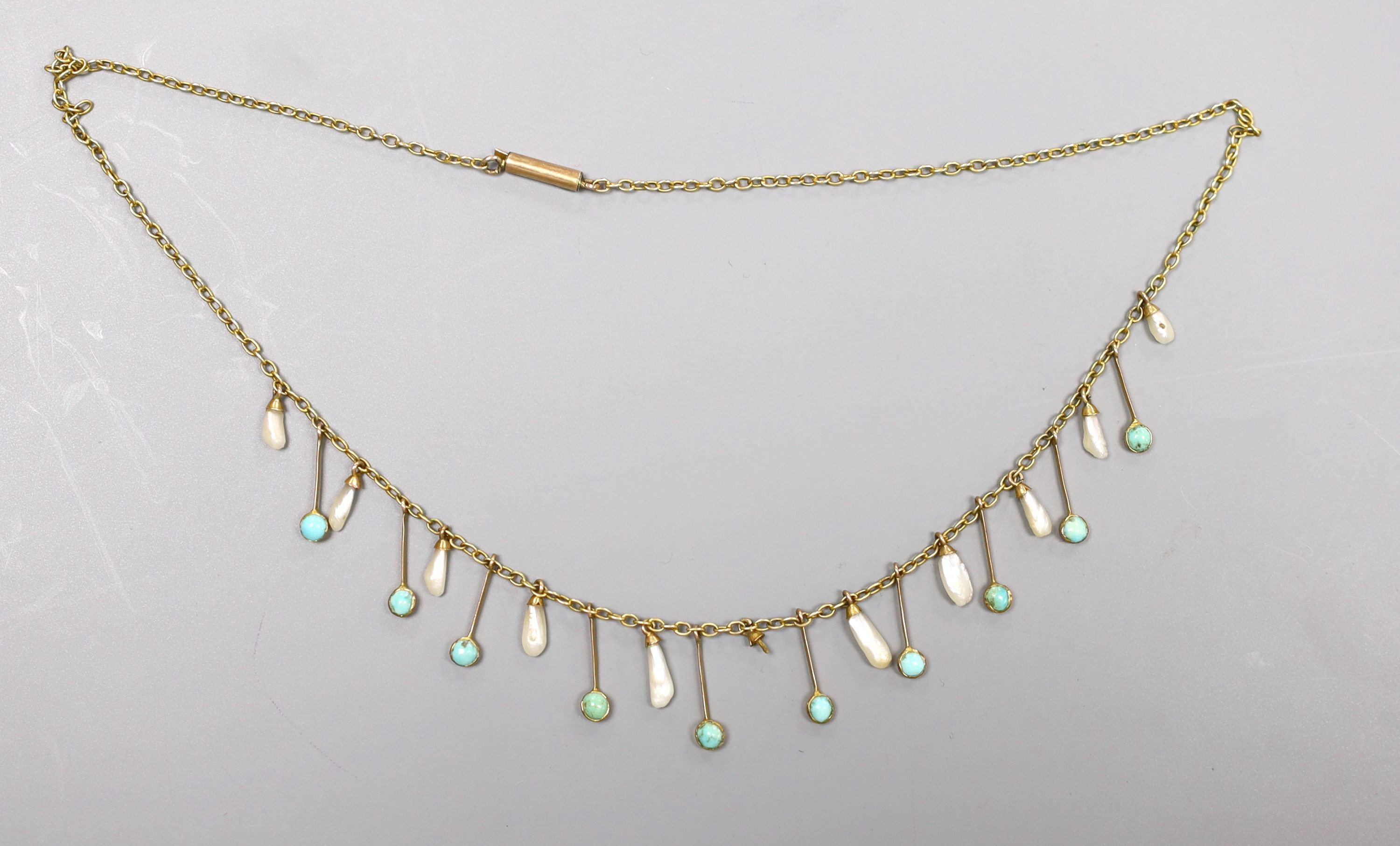 An Edwardian 9ct, baroque pearl and turquoise set drop fringe necklace, 38cm, gross 4.6 grams.